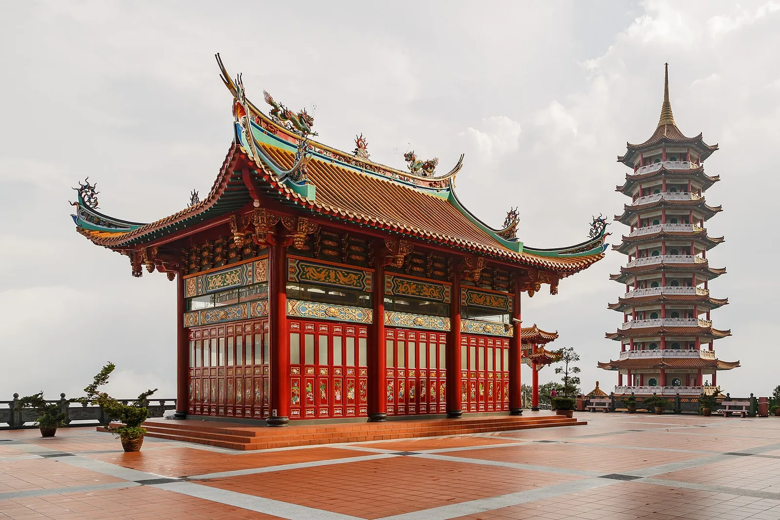 Red-and-gold hall and tall pagoda at Chin Swee Caves Temple