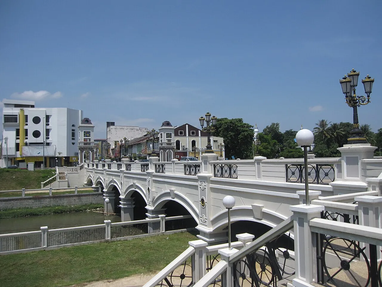 Decorative bridge across the Kinta River with Ipoh buildings behind it