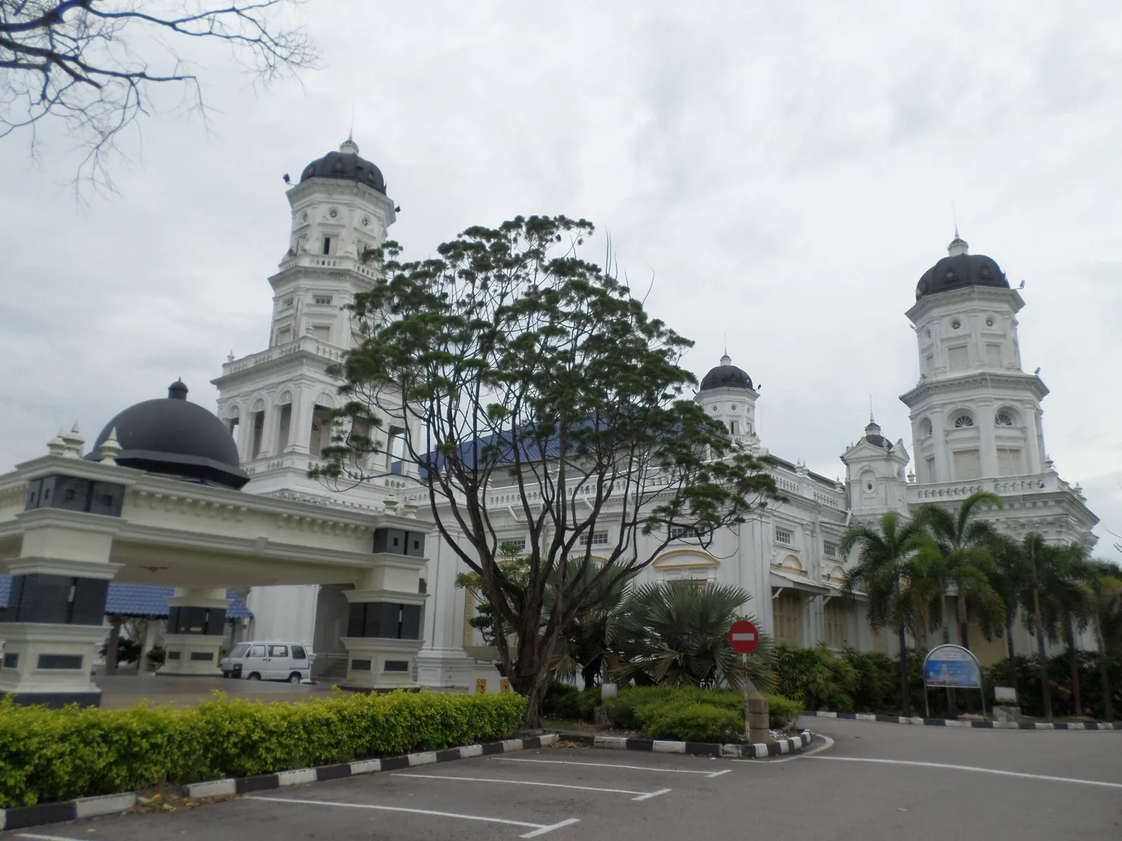 White towers and dark domes of Sultan Abu Bakar State Mosque in Johor Bahru