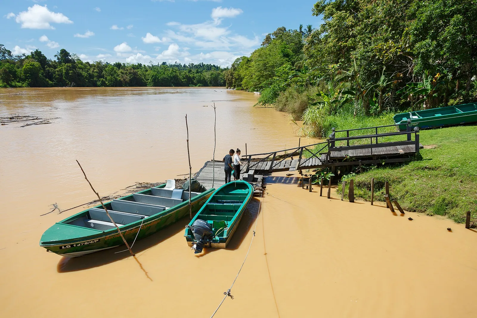 Small boats beside a riverside jetty at Sukau in Sabah