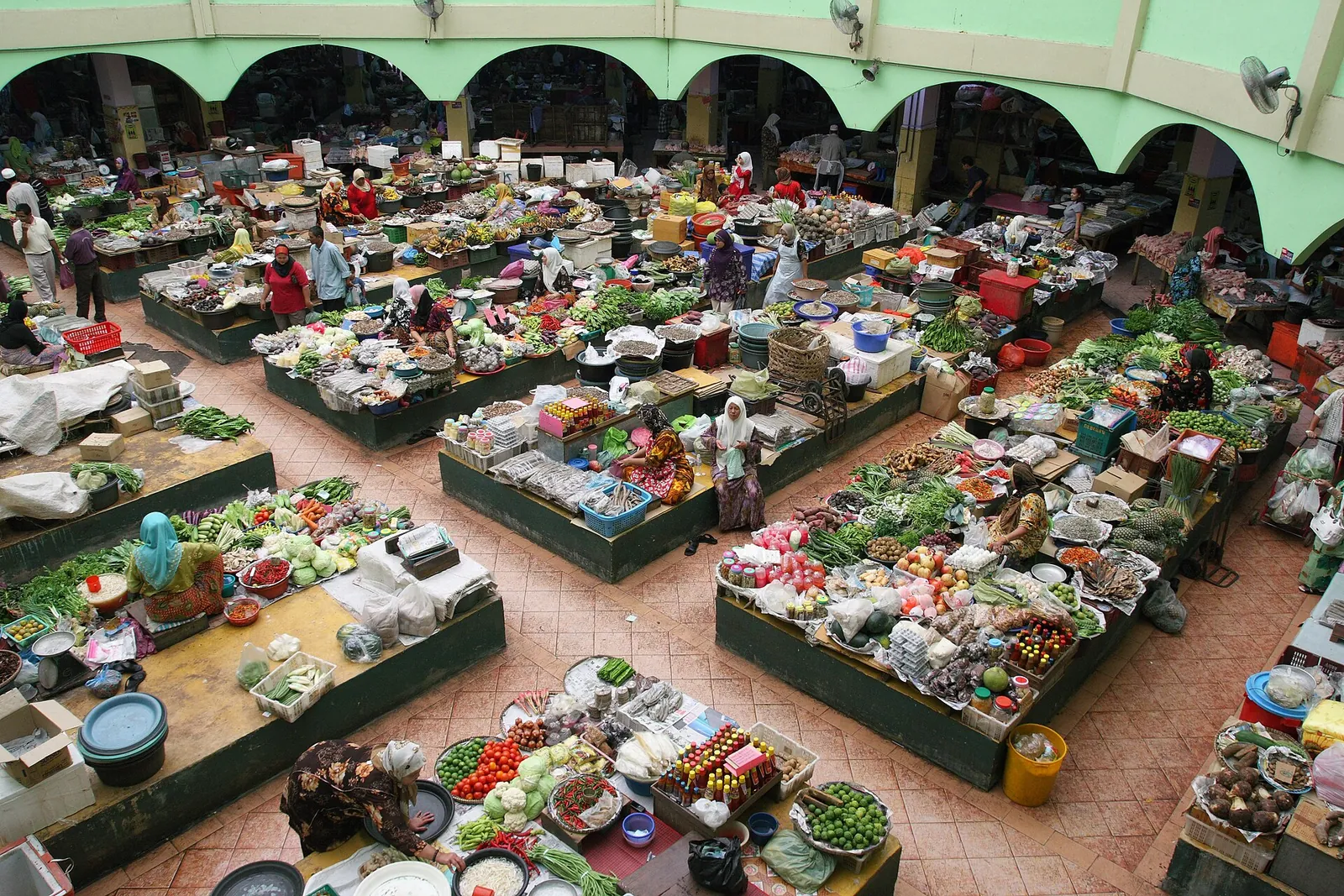 Overhead view of colorful produce stalls inside Siti Khadijah Market in Kota Bharu