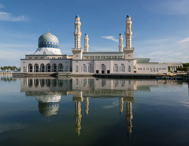 Blue-domed Kota Kinabalu City Mosque reflected in surrounding water