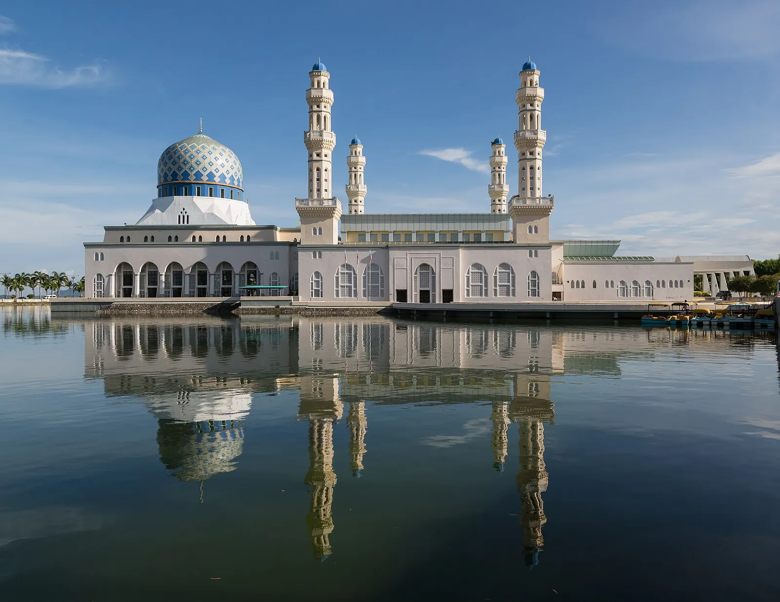 Blue-domed Kota Kinabalu City Mosque reflected in surrounding water