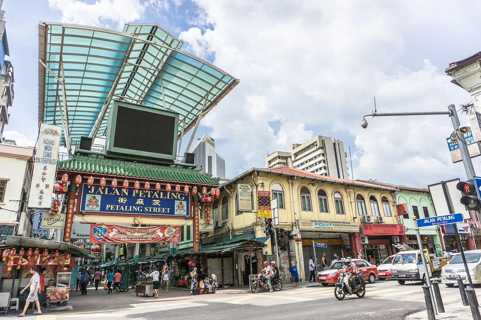 Pedestrians and buildings around the Petaling Street entrance in Kuala Lumpur