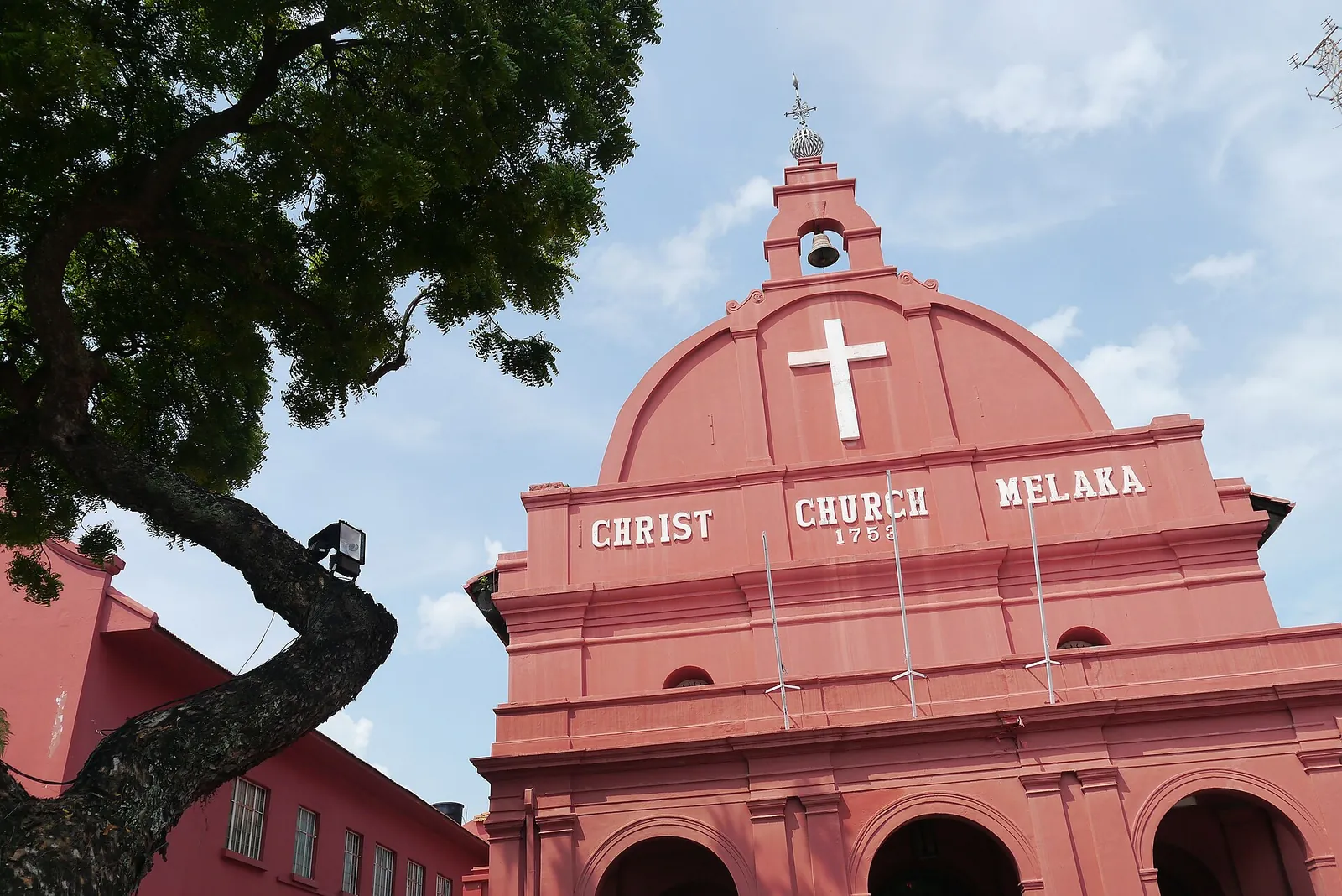 Red Christ Church facade with a white cross in Melaka