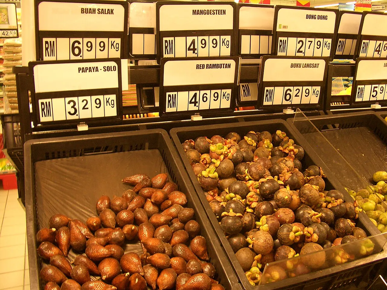 Bins of salak and mangosteen displayed in a Melaka supermarket