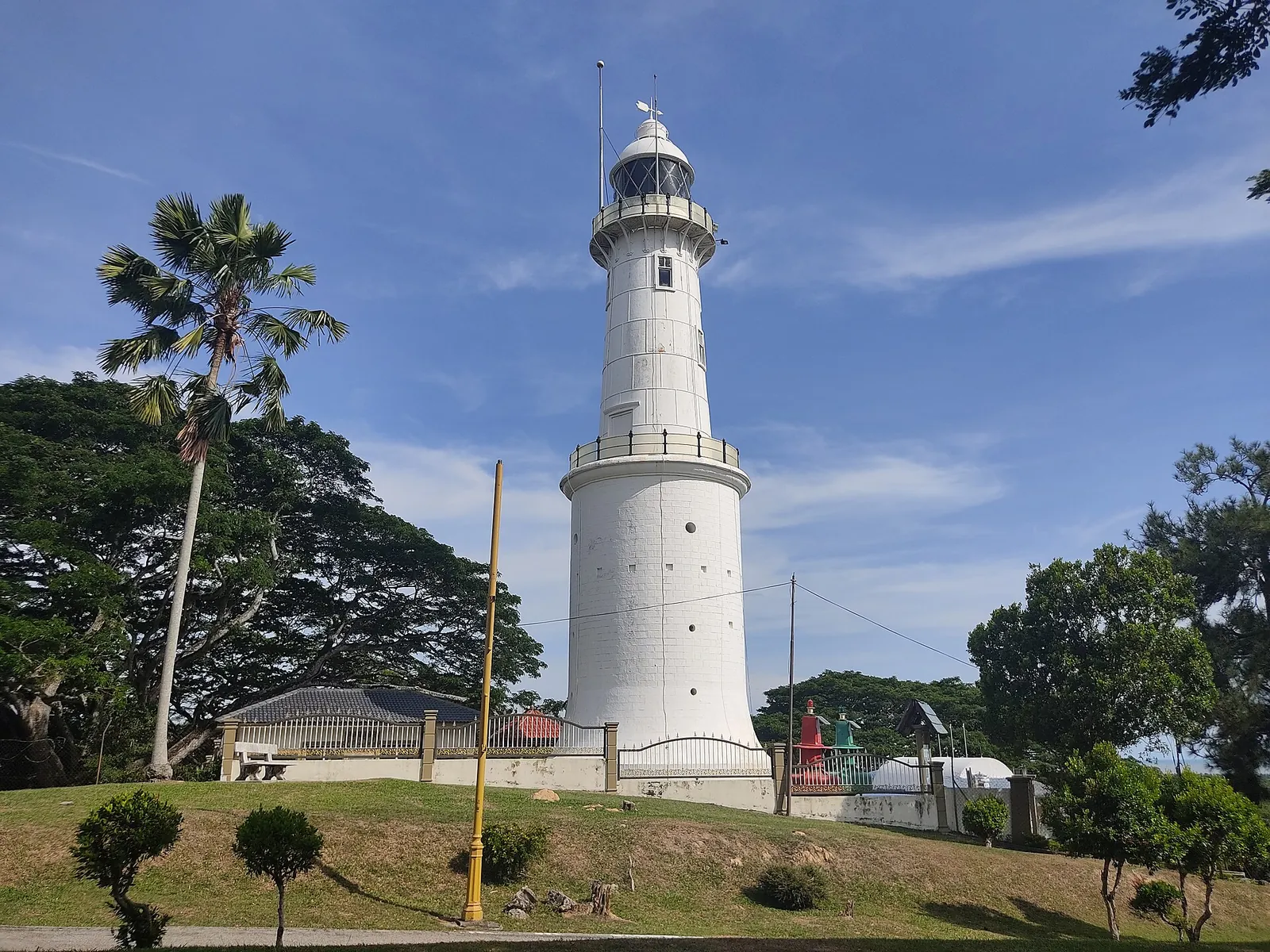 White lighthouse on Bukit Melawati in Kuala Selangor under a blue sky