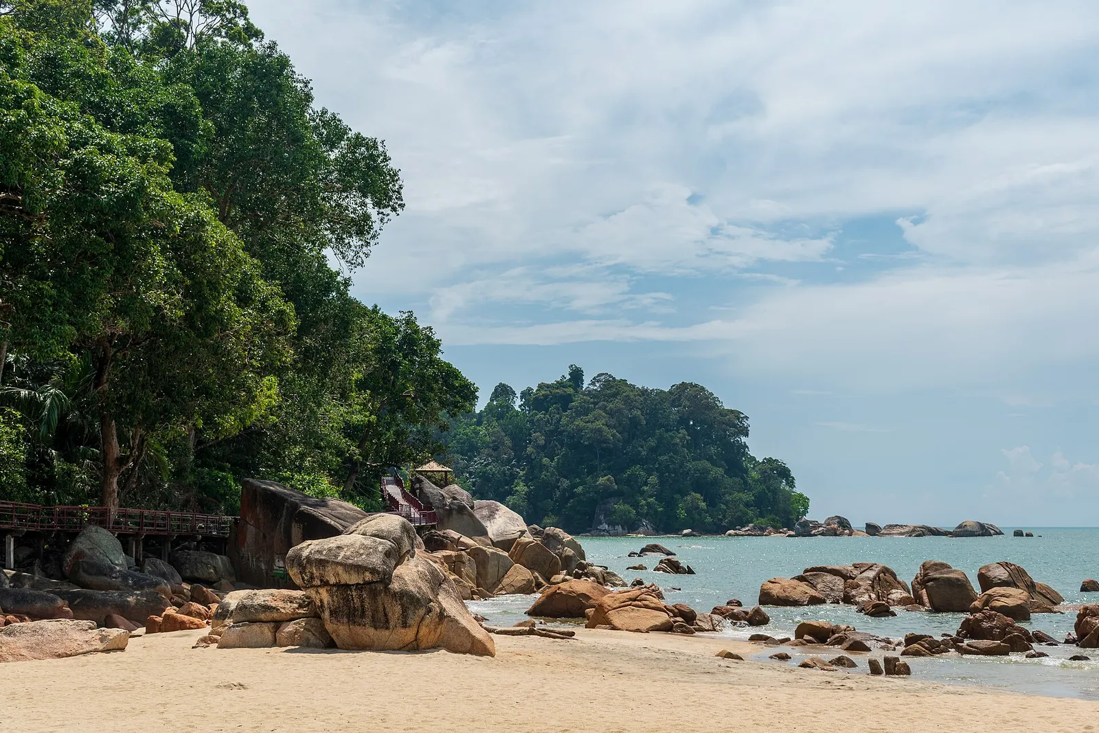 Sand, large rocks and trees beside the sea at Teluk Cempedak in Kuantan