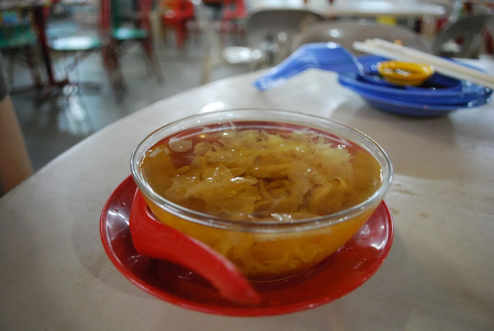 Glass bowl of cloud-ear and sea-coconut dessert on a table in Kuantan