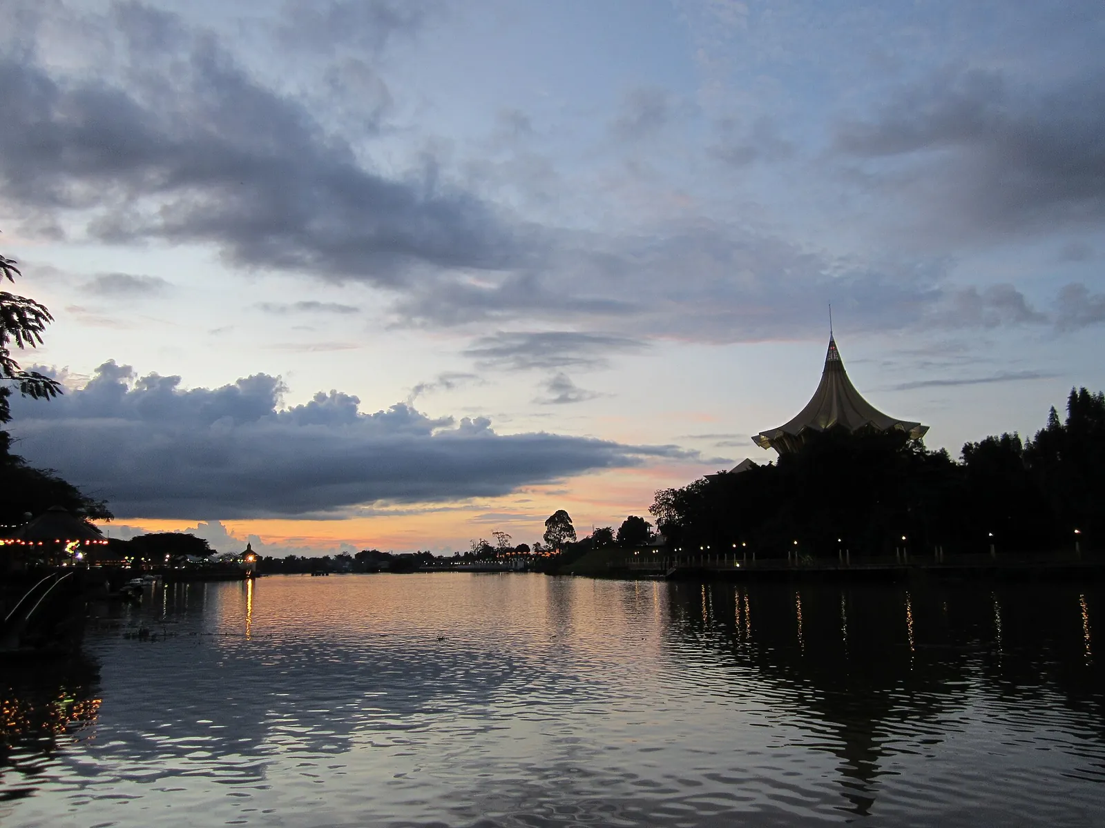 The Sarawak River and waterfront buildings at sunset in Kuching