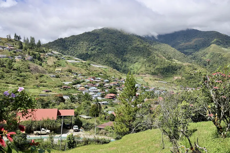 Green hills and village buildings viewed from Kundasang War Memorial