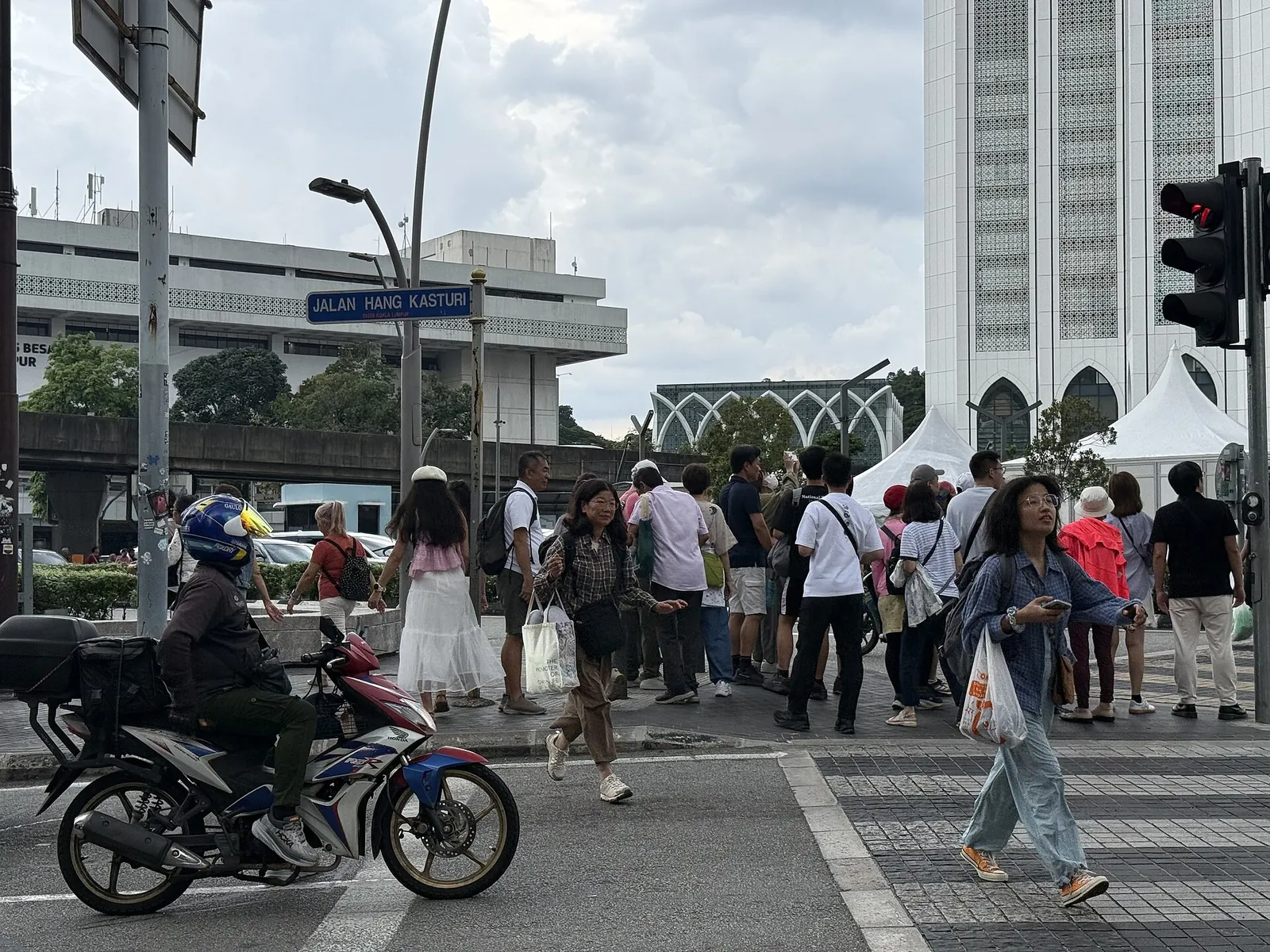 Pedestrians crossing at traffic lights near Pasar Seni in Kuala Lumpur