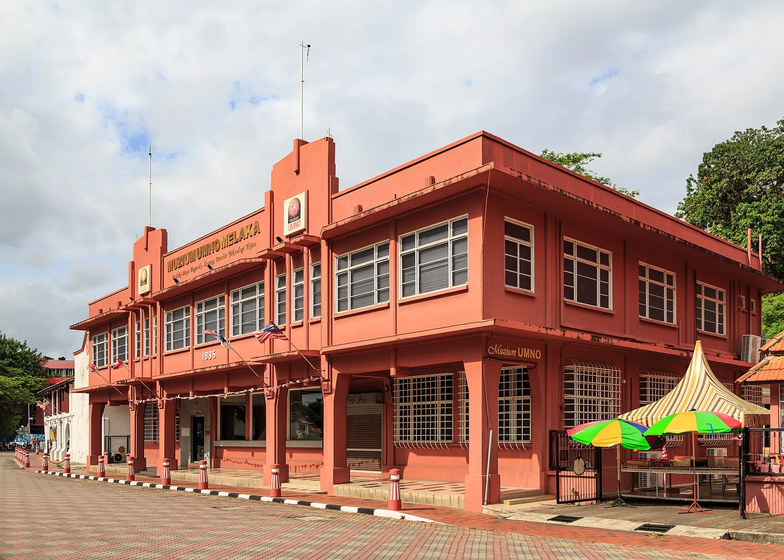 A red historic museum building and covered frontage in Melaka