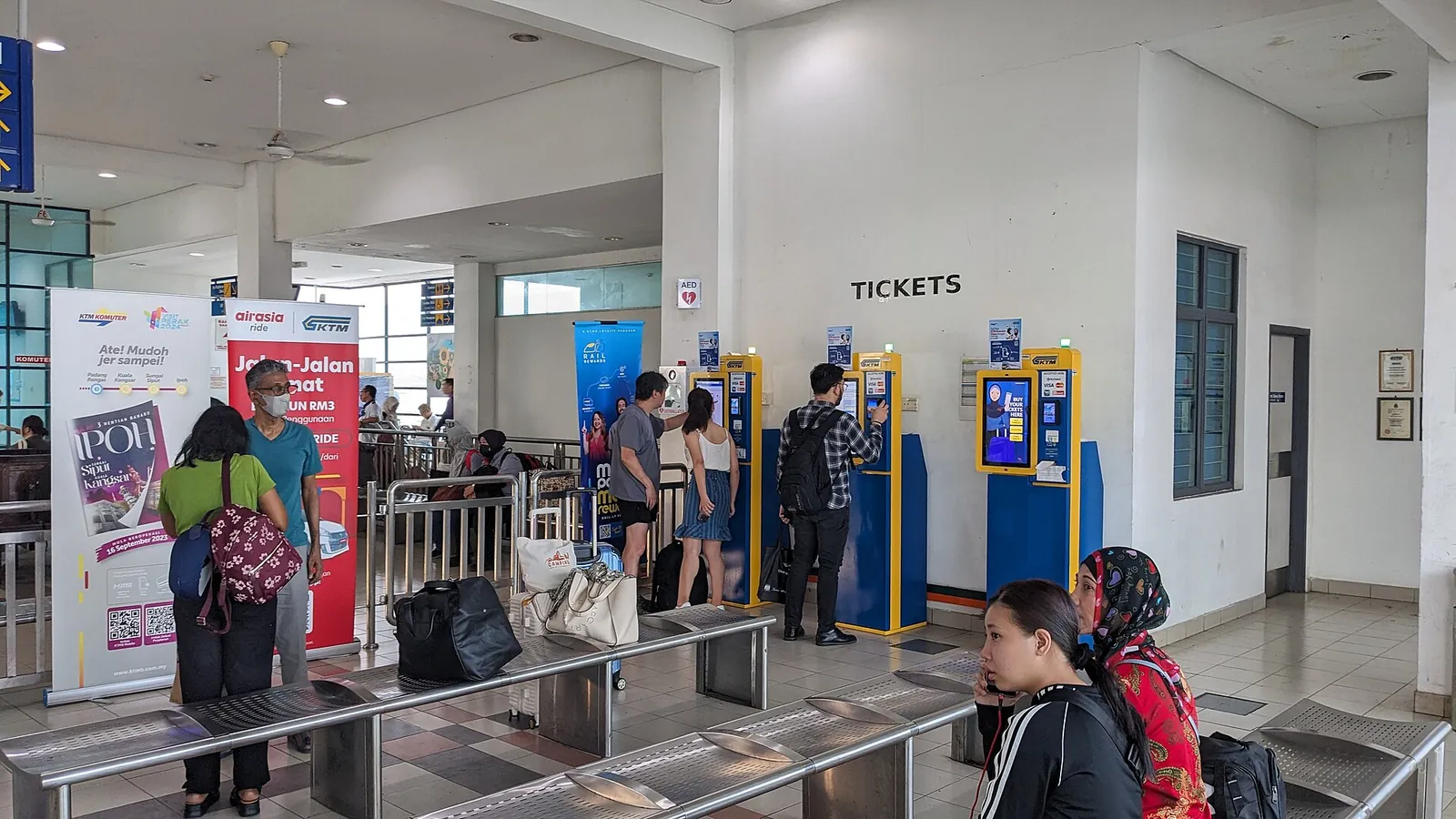Passengers and ticket machines in the concourse of Butterworth railway station