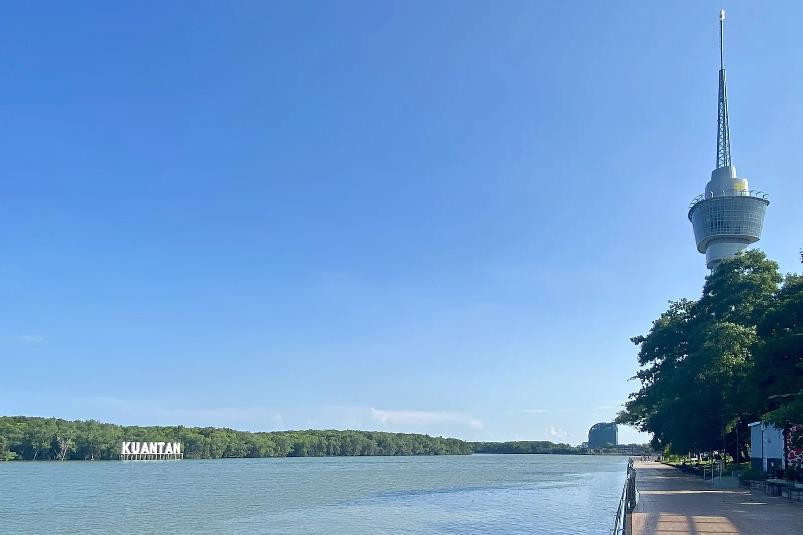 Riverfront promenade and Kuantan 188 Tower under blue sky