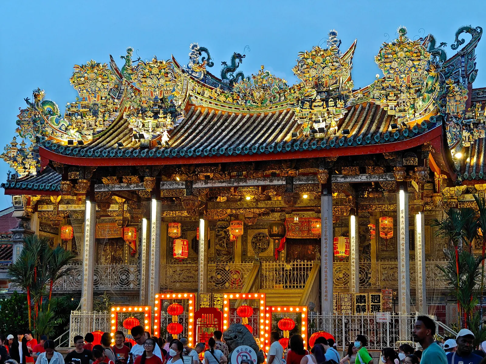 Khoo Kongsi’s ornate clanhouse illuminated beneath a bright blue sky