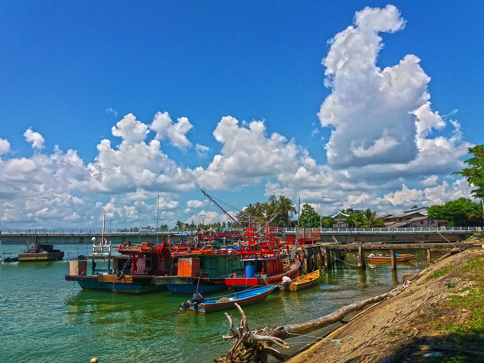 Colourful boats and a jetty beside the water at Kampung Kuala Besut