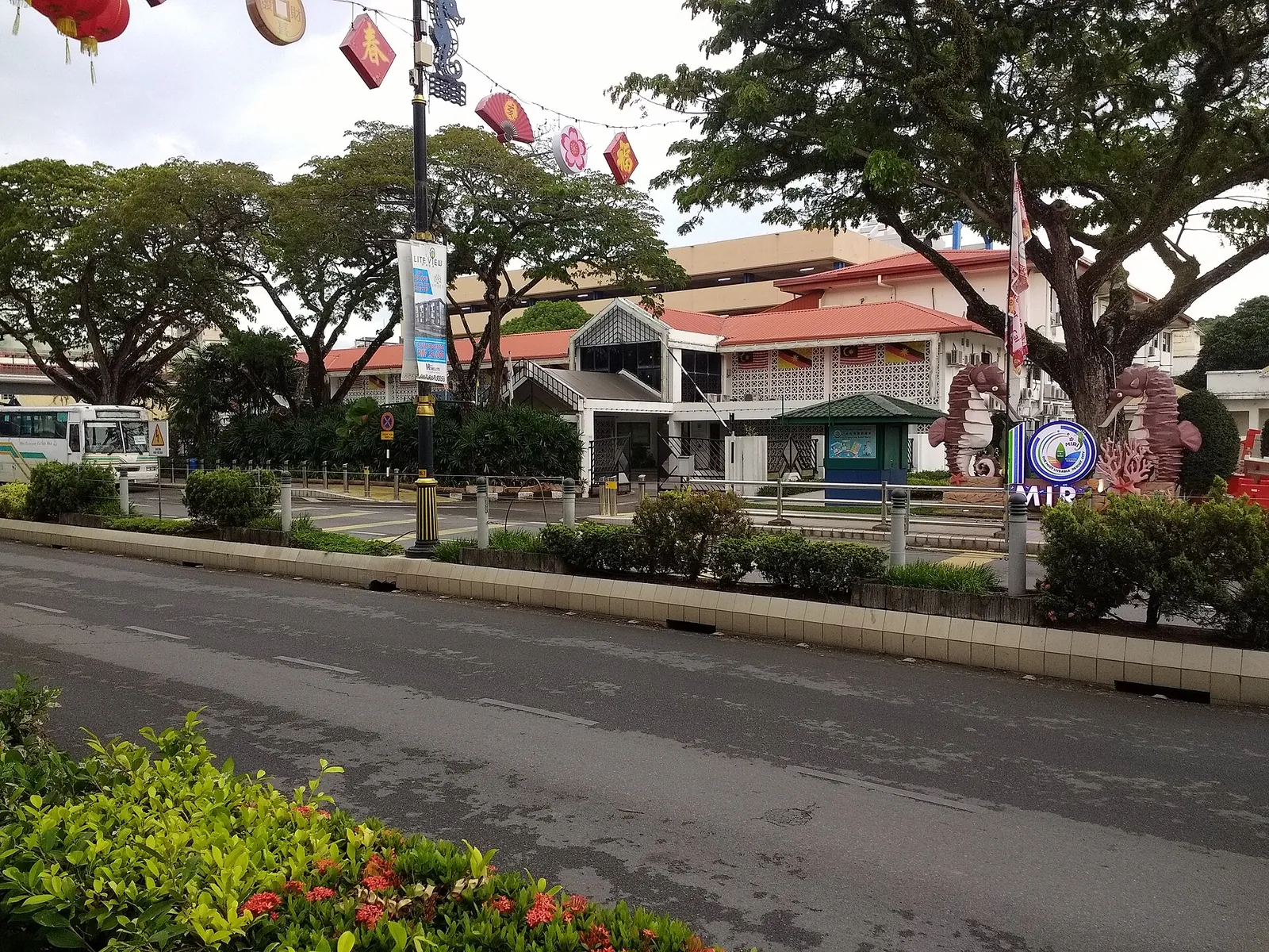 The Miri City Council building behind roadside greenery