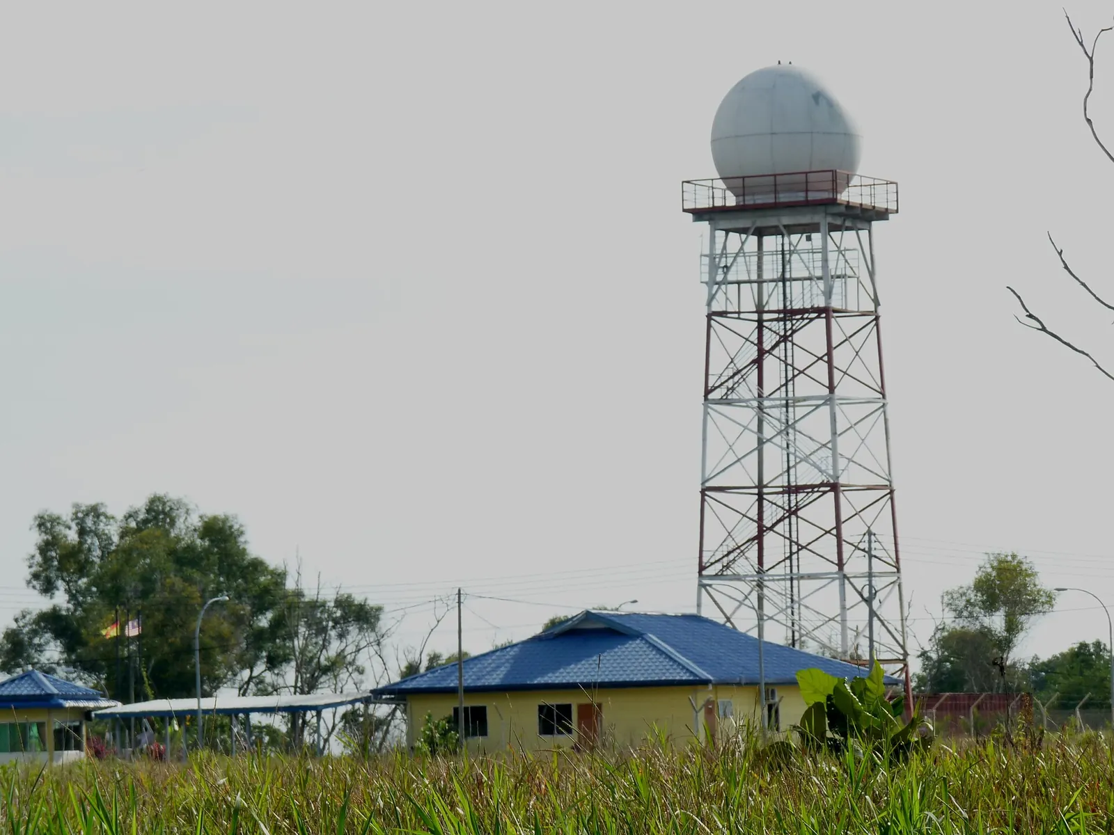 A white weather-radar dome above a tower on Canada Hill in Miri