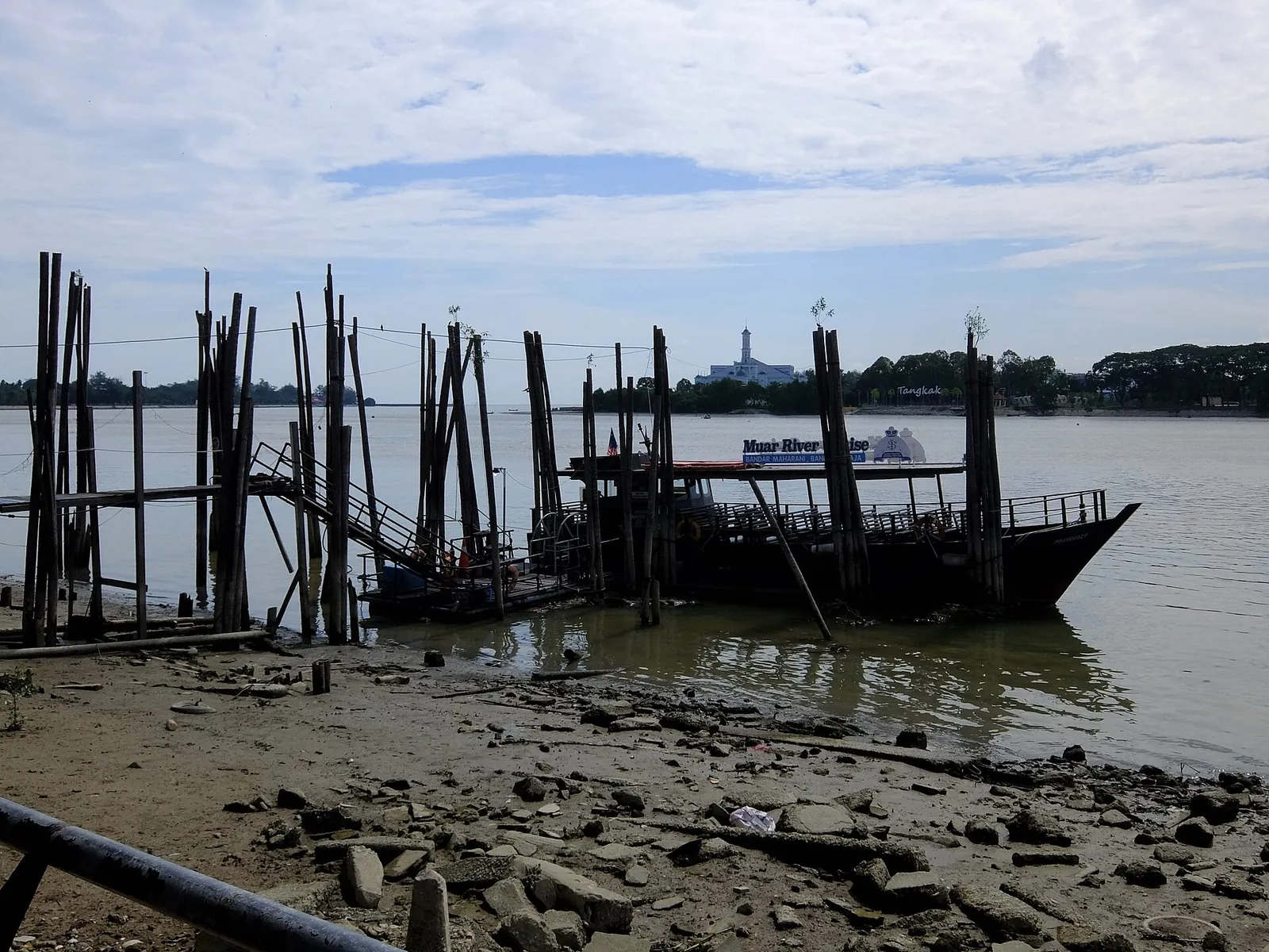Timber jetty and boat at the Muar River Cruise Terminal