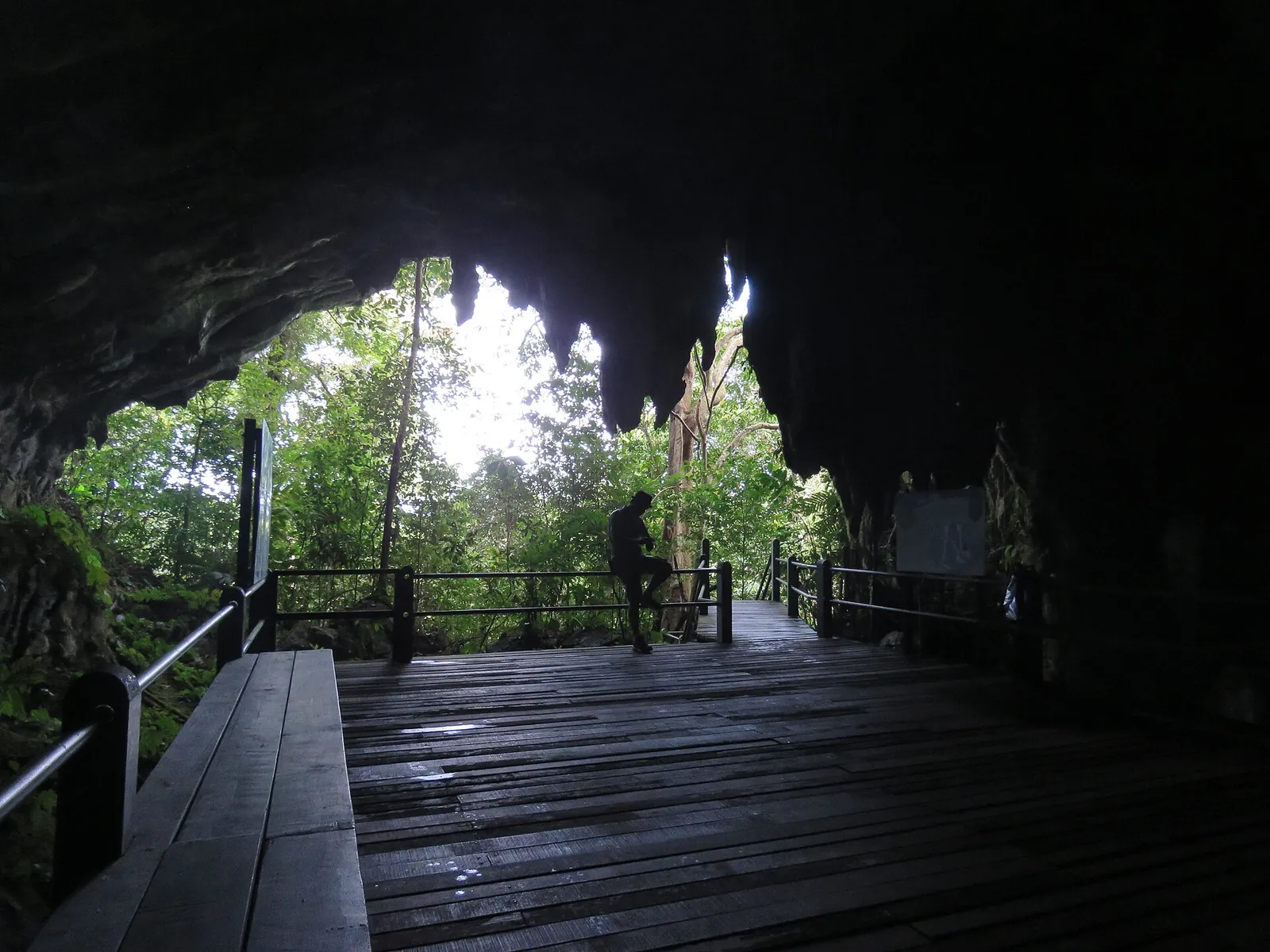 A wooden visitor platform looking out from Cave of the Winds in Mulu