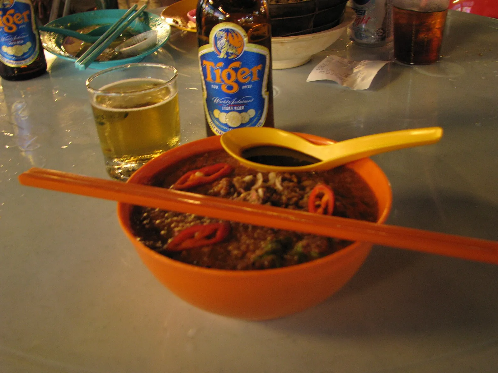 Noodles in a bowl at a Penang food-court table