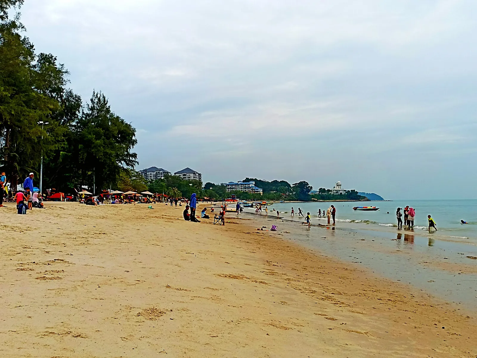 Visitors and shoreline at Teluk Kemang Beach in Port Dickson