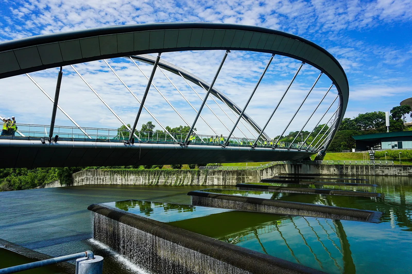 Curved pedestrian bridge over water at Seri Empangan Park in Putrajaya