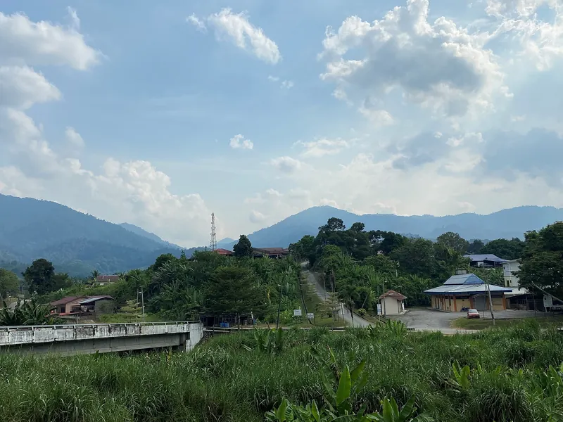 Green hills and village buildings at Kampung Baru Teras outside Raub