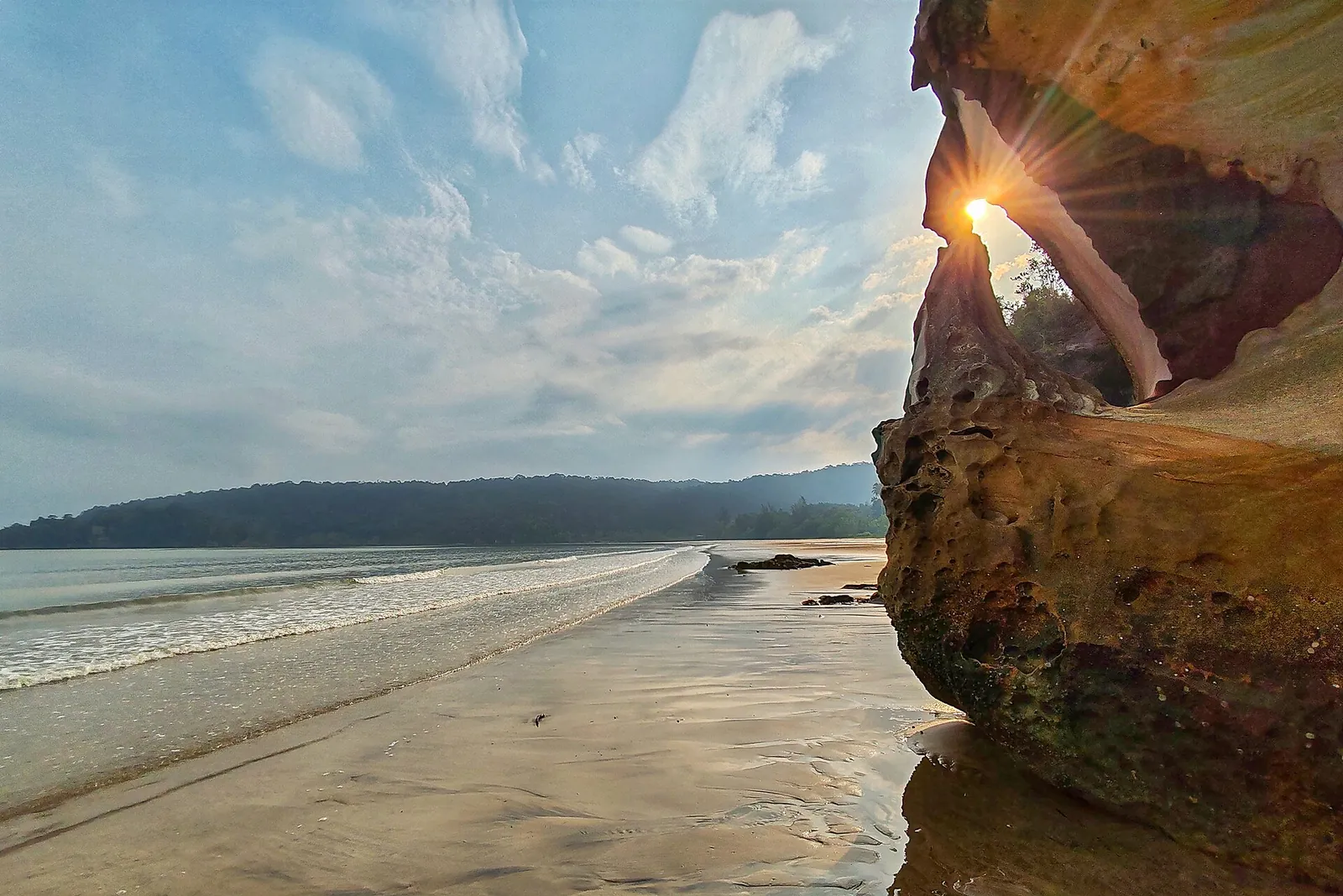 Sunlight through coastal rock formations at Bako National Park