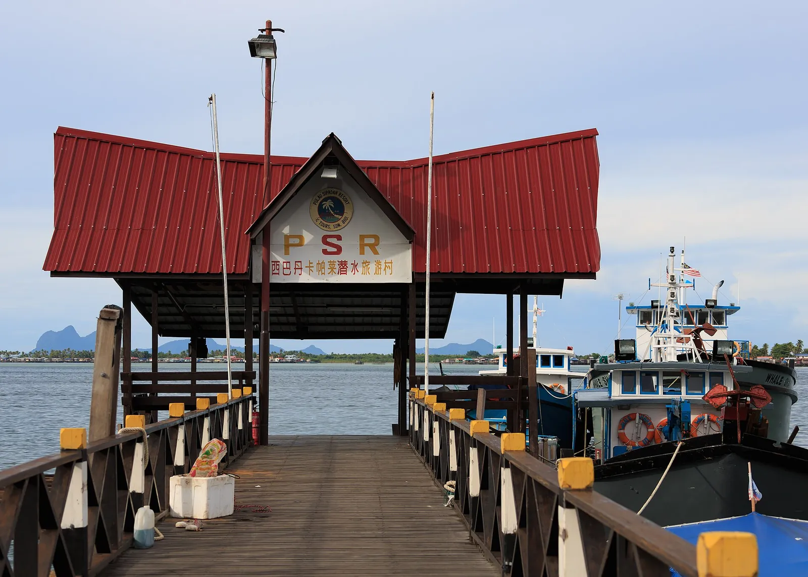 A timber walkway and roofed entrance at PSR Jetty in Semporna