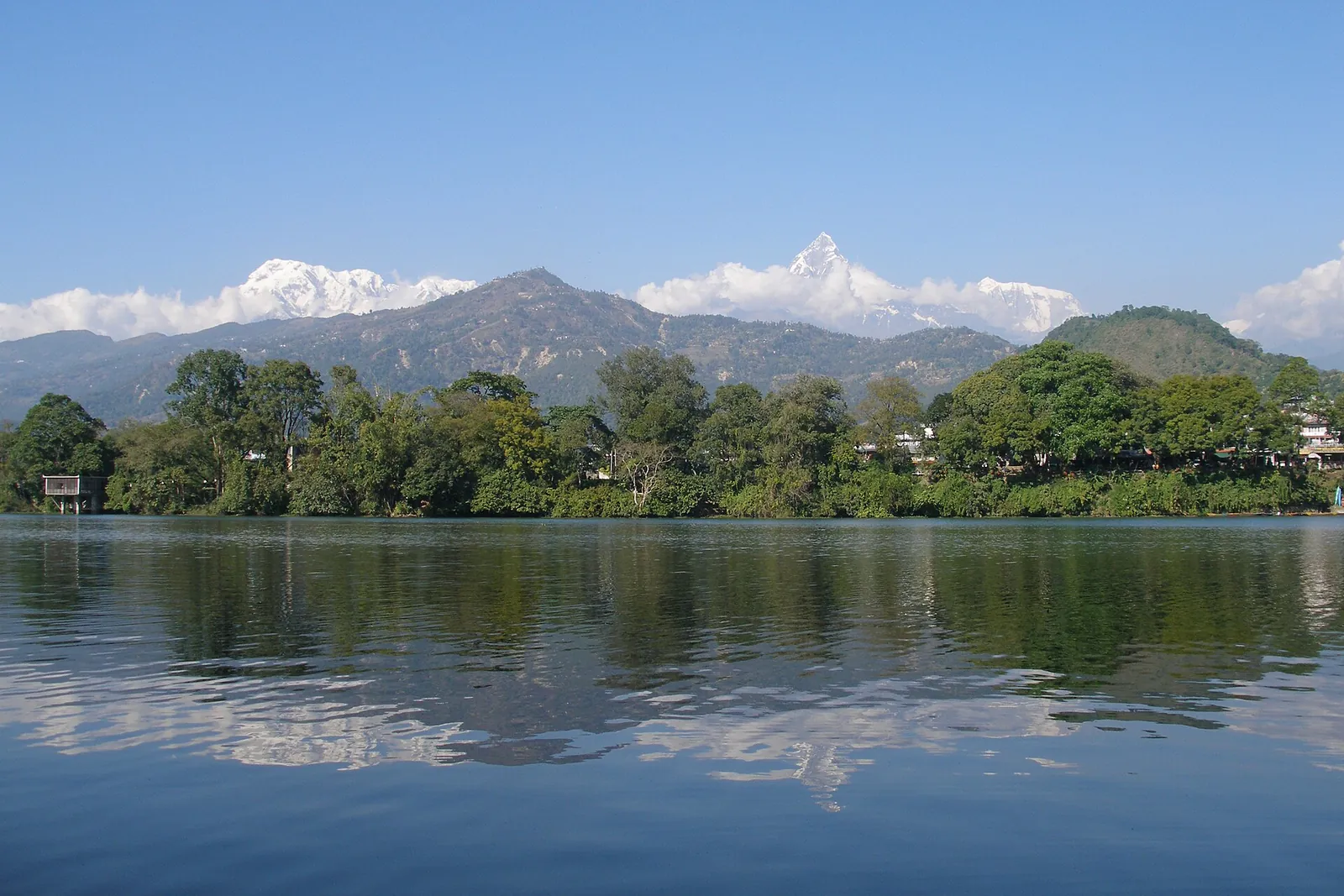 Snow peaks reflected in Phewa Lake at Pokhara on a clear day