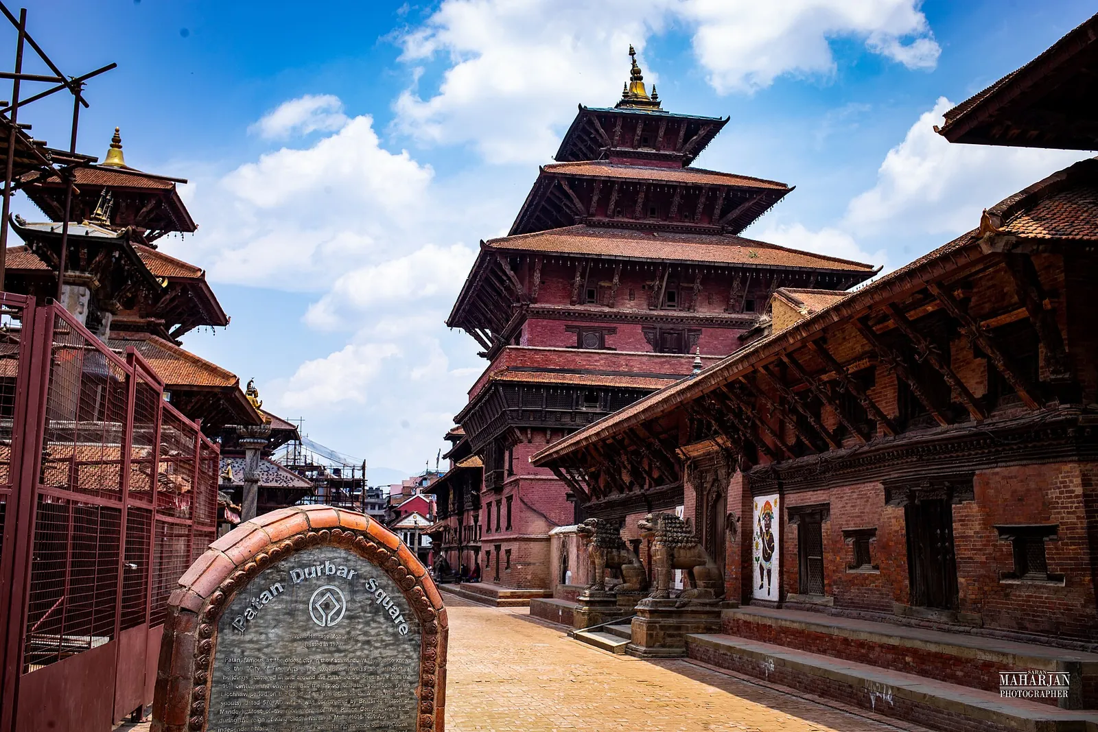 Tiered temples on Patan Durbar Square under a blue sky