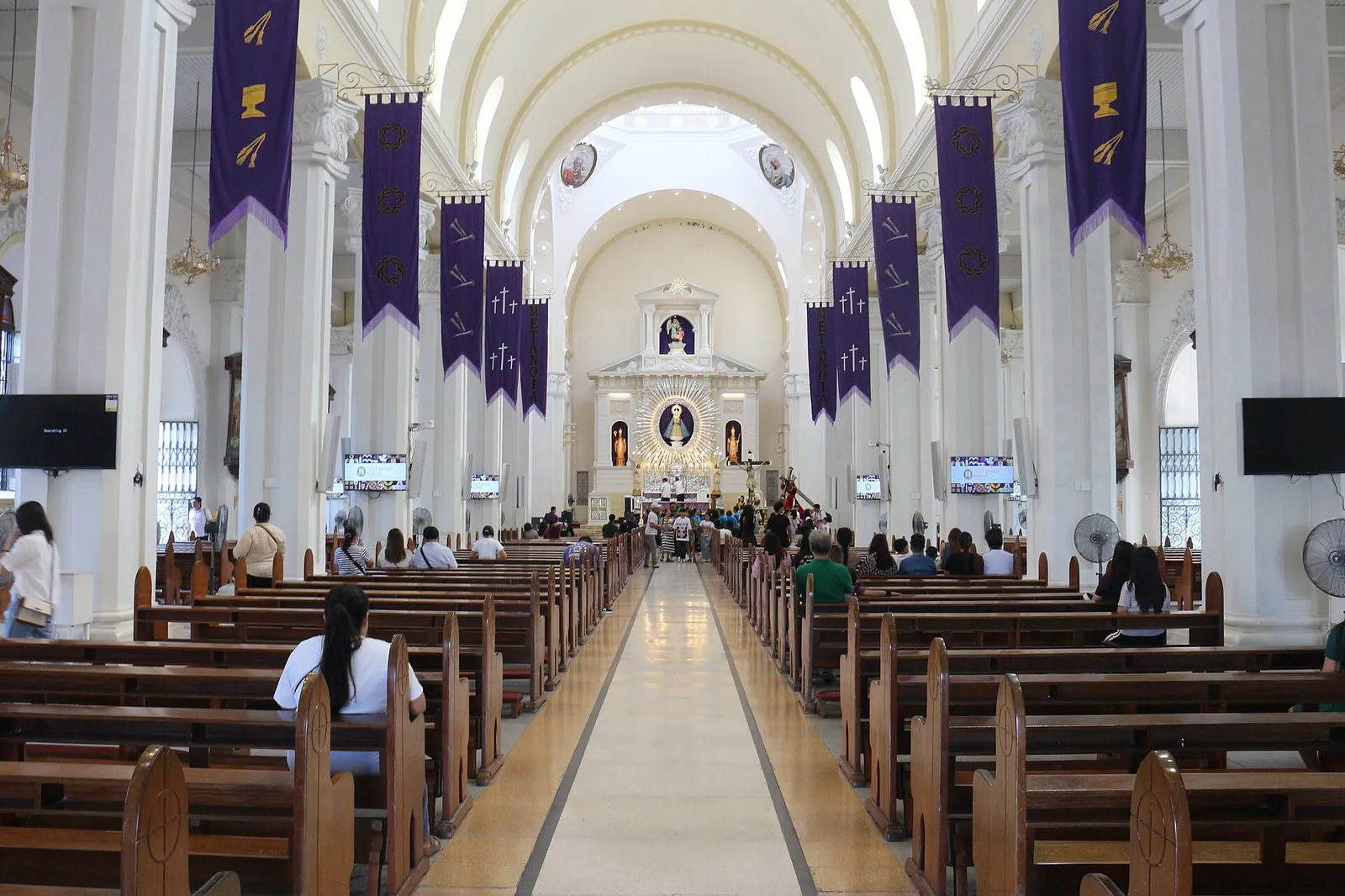 Arched nave and wooden pews inside Holy Rosary Parish in Angeles
