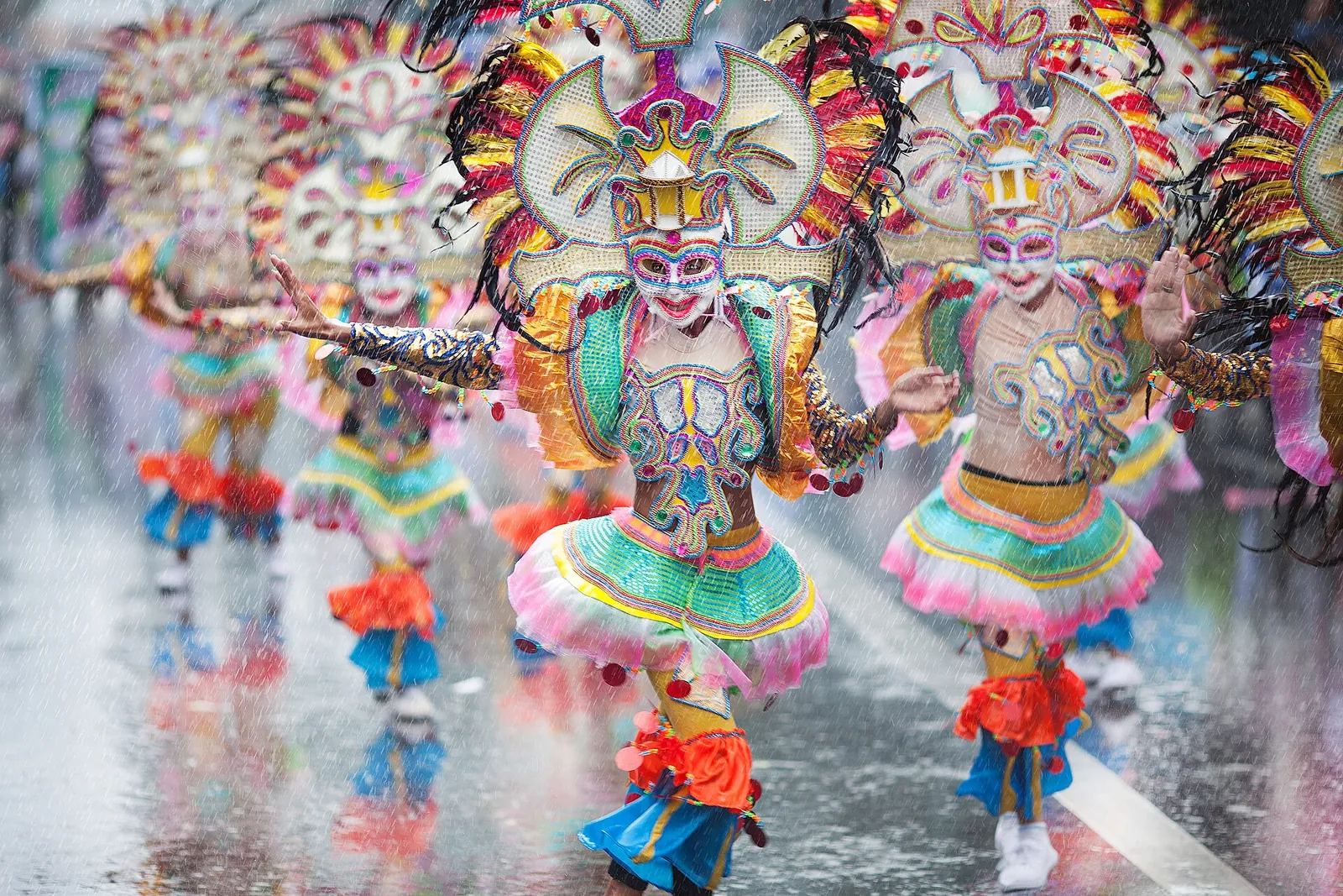 Colourful masked dancers in rain during Bacolod’s MassKara festivities