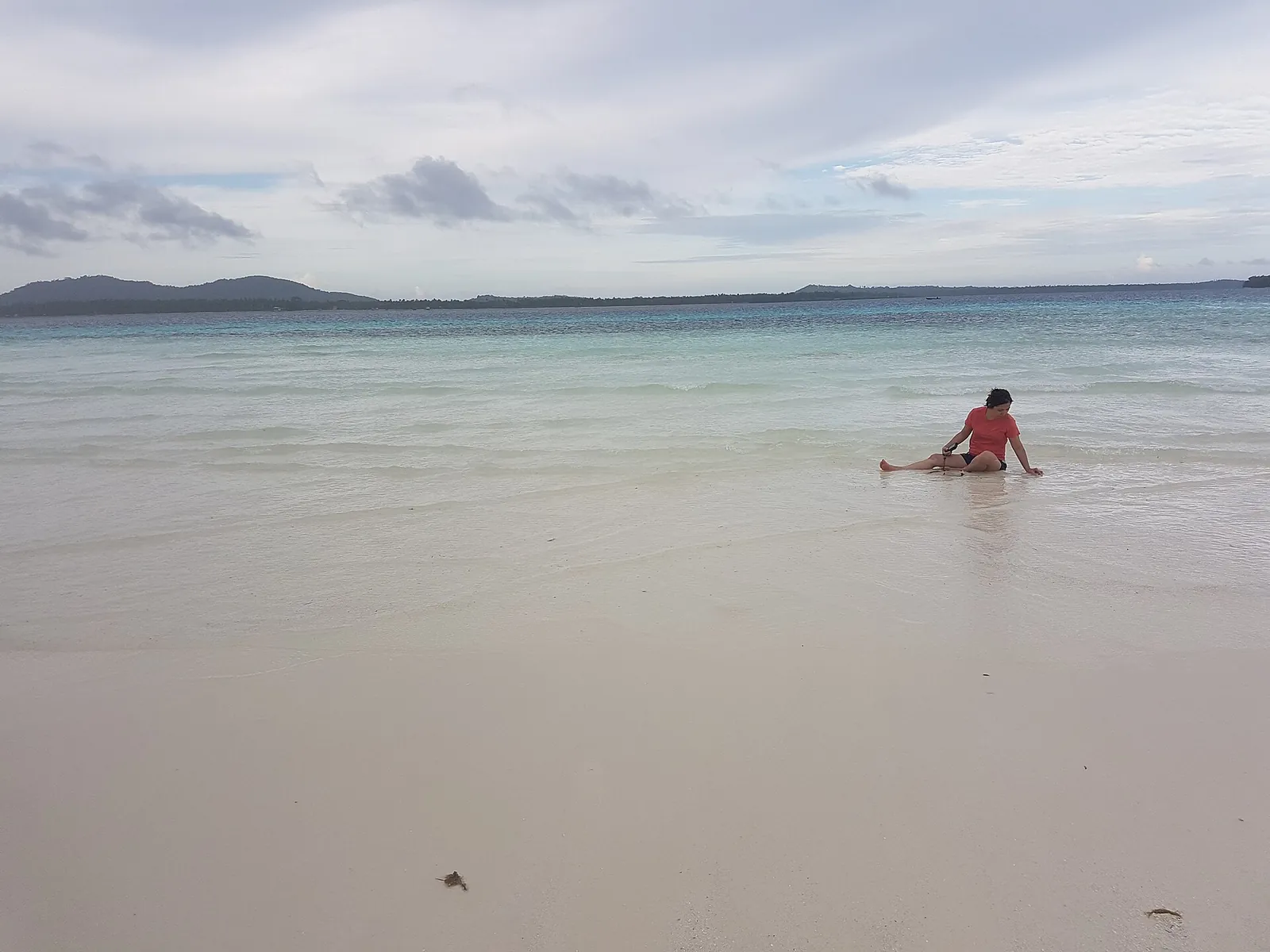 Pale sand and shallow water at Benlen Sandbar off Candaraman Island in Balabac