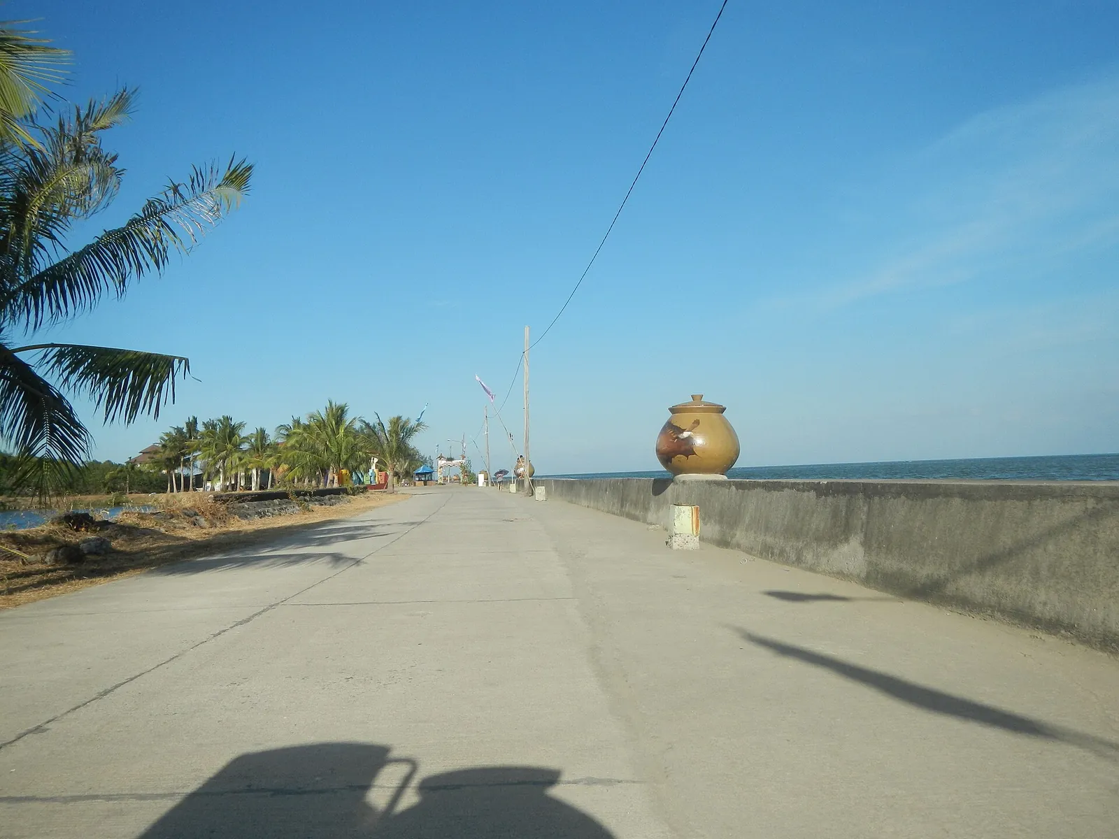 Sunny coastal path at the Tortugas wetland park in Balanga