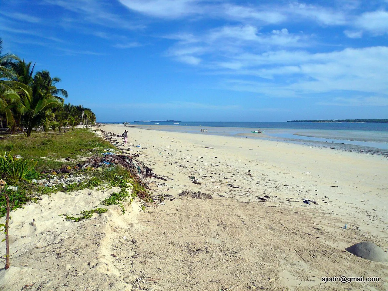 Broad pale beach and shallow blue water in Santa Fe on Bantayan Island