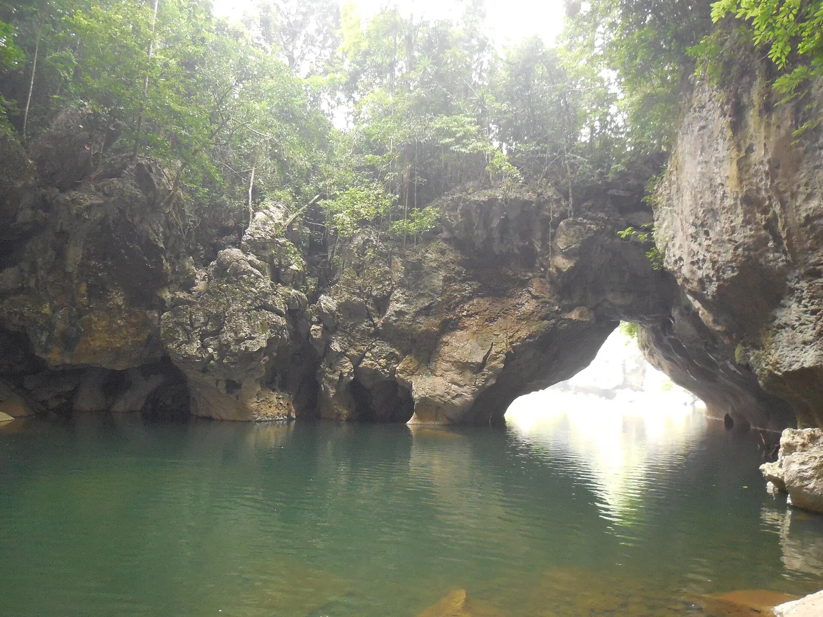 Green water beneath the rock arch at Sohoton Natural Bridge in Basey