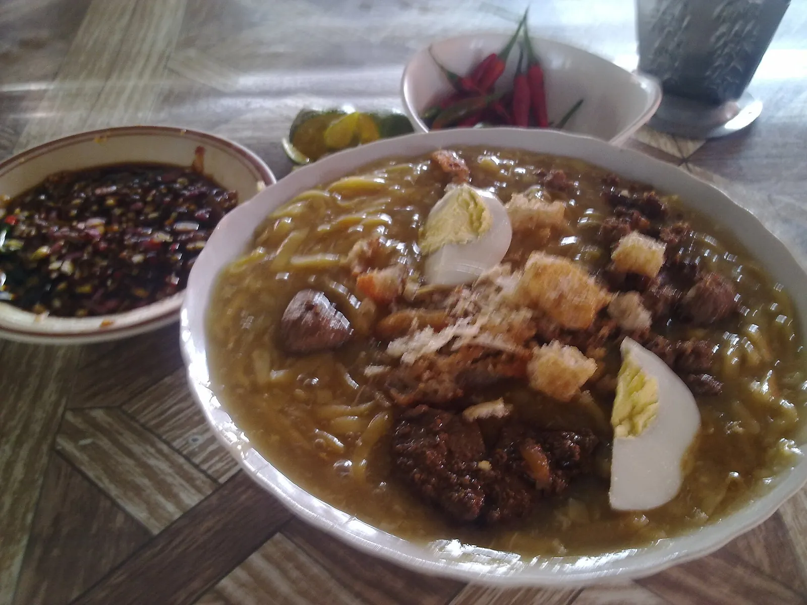 Bowl of thick Batangas lomi noodles with egg and meat toppings