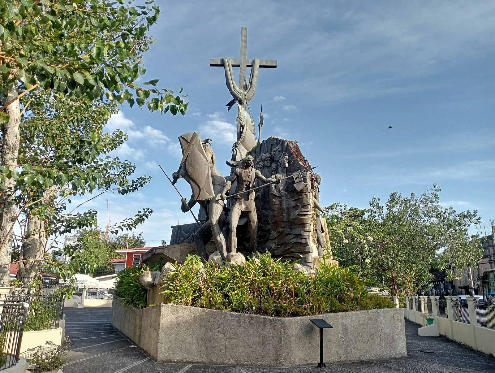 Sculptures and a cross in the landscaped Heritage of Cebu Monument