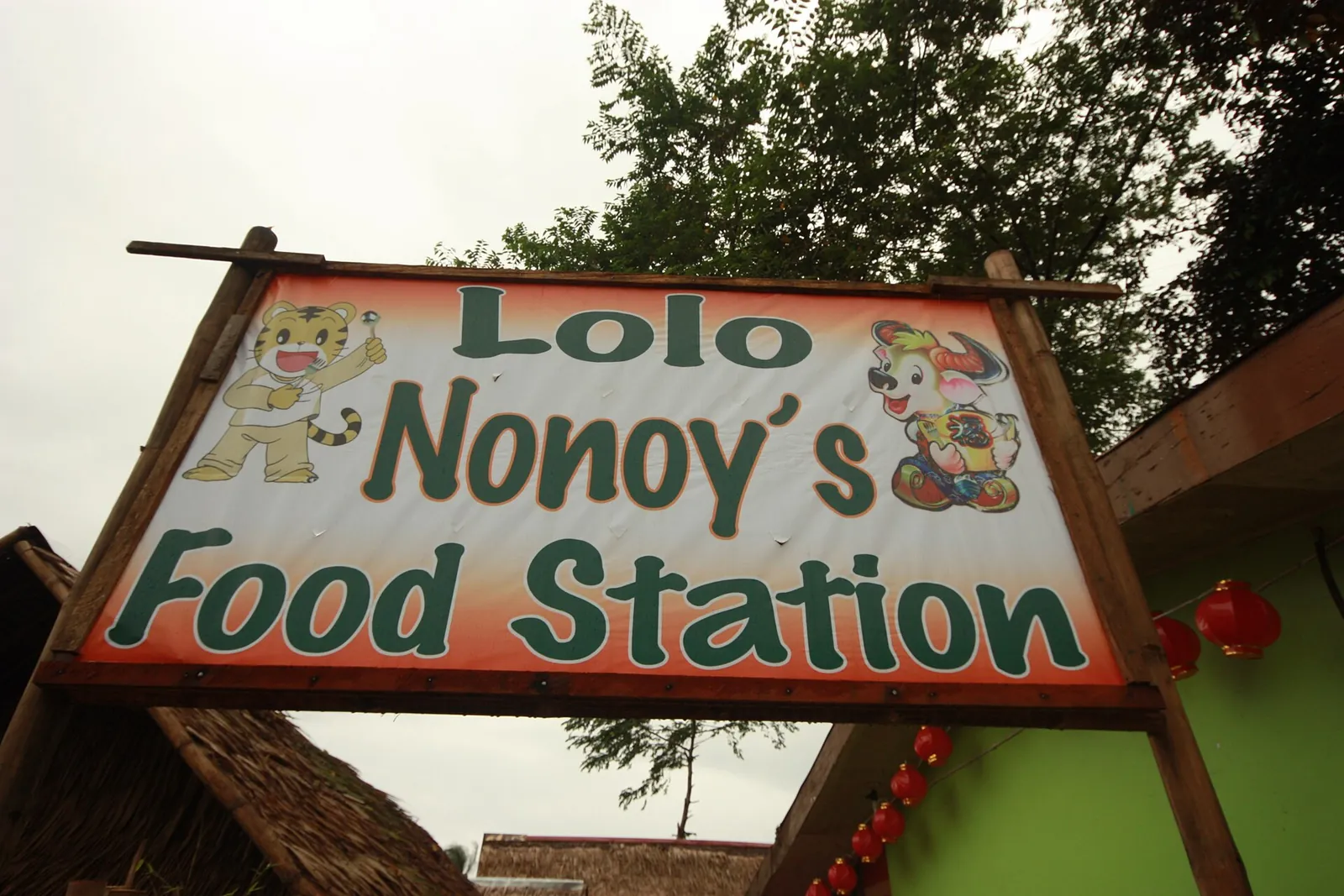 Lolo Nonoy food-station sign hanging above a restaurant entrance in Coron town