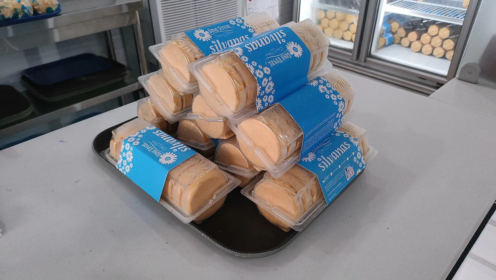 Clear packages of Sans Rival Silvanas stacked on a tray in Dumaguete City