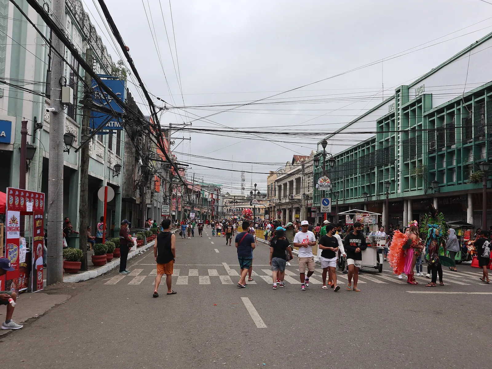 People walking along JM Basa Street between heritage buildings in Iloilo City