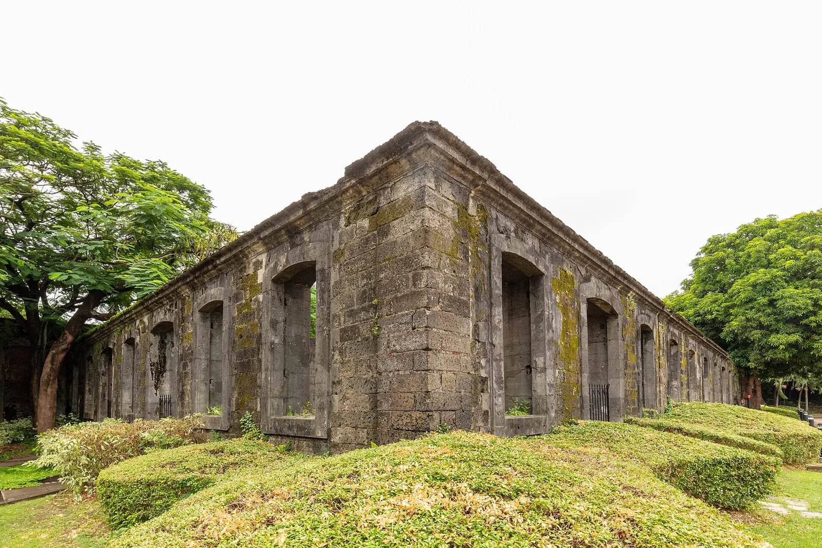 Weathered stone walls and arched openings at Fort Santiago in Manila
