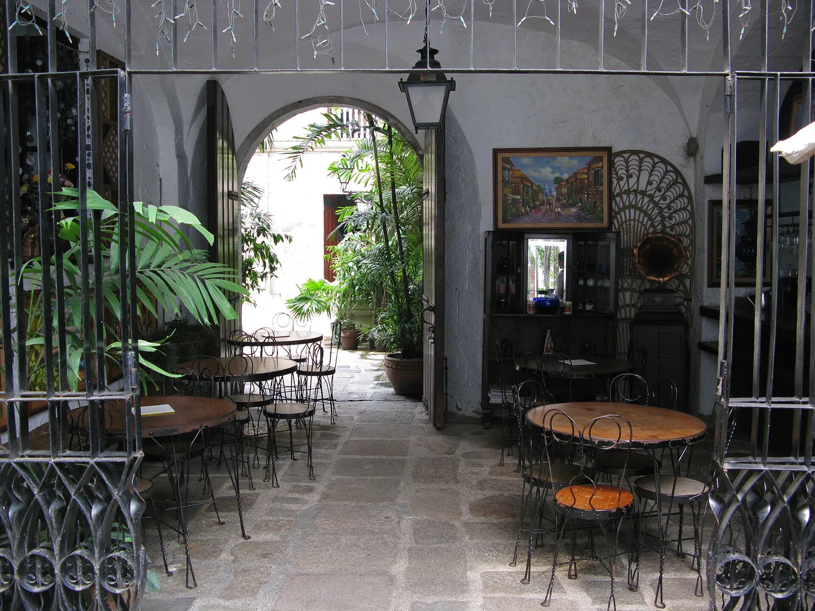 Tables and chairs in an arched patio in Intramuros, Manila