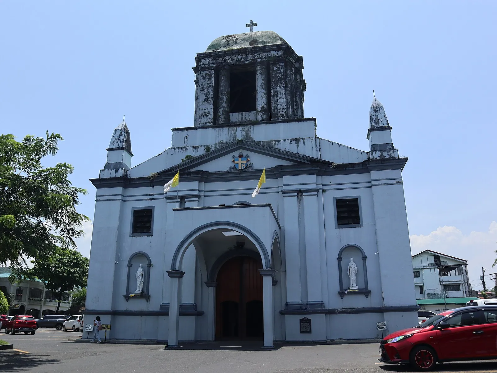 White facade and weathered tower of Legazpi Cathedral