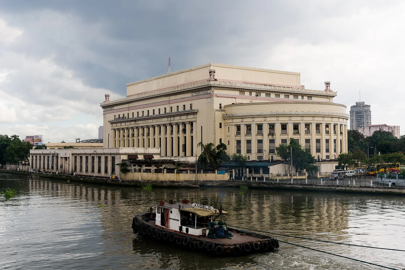 Manila Central Post Office beside the Pasig River with a boat in the foreground