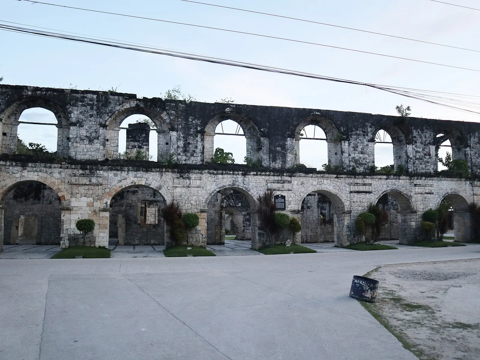 Two levels of coral-stone arches at the Cuartel ruins in Oslob
