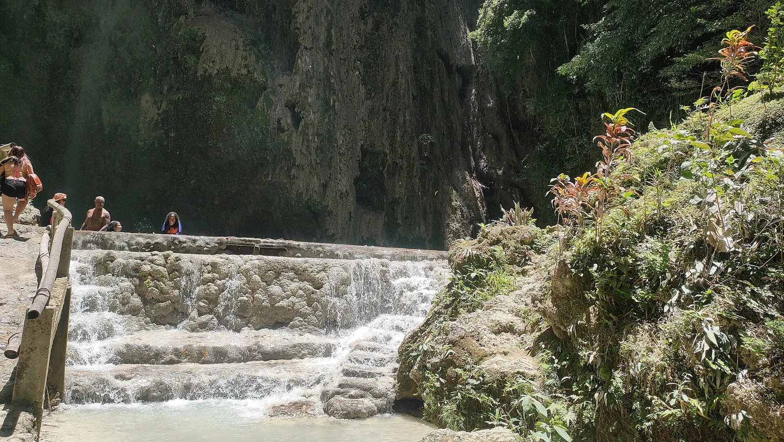 Rock terraces and shaded limestone walls at Tumalog Falls near Oslob